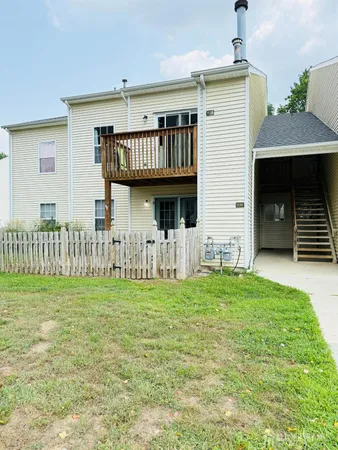 a backyard of a house with table and chairs