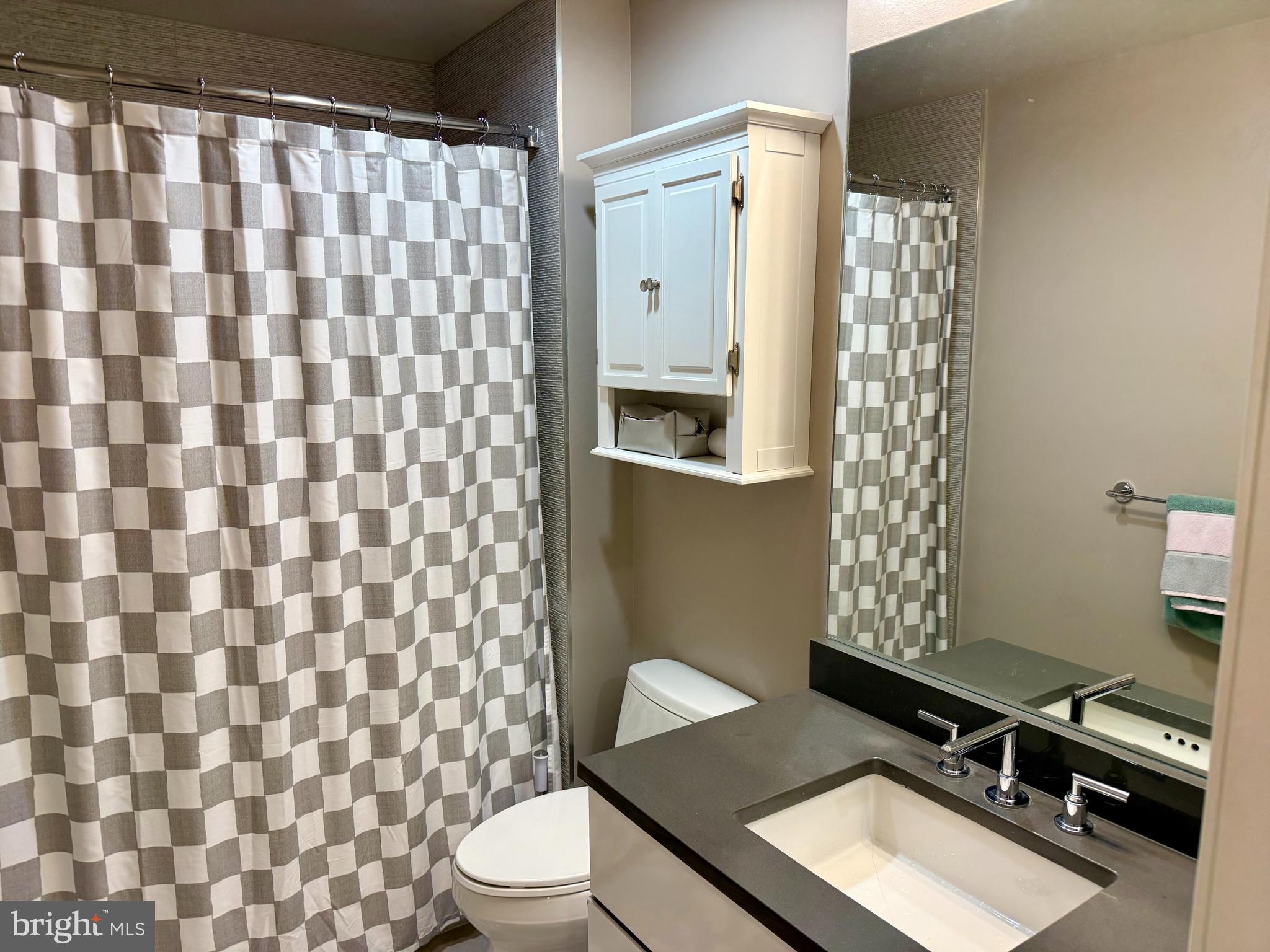 1311 13th Street Northwest, Unit T05 Washington, DC 20005 - Photo 8 of 17 a bathroom with a sink toilet and shower