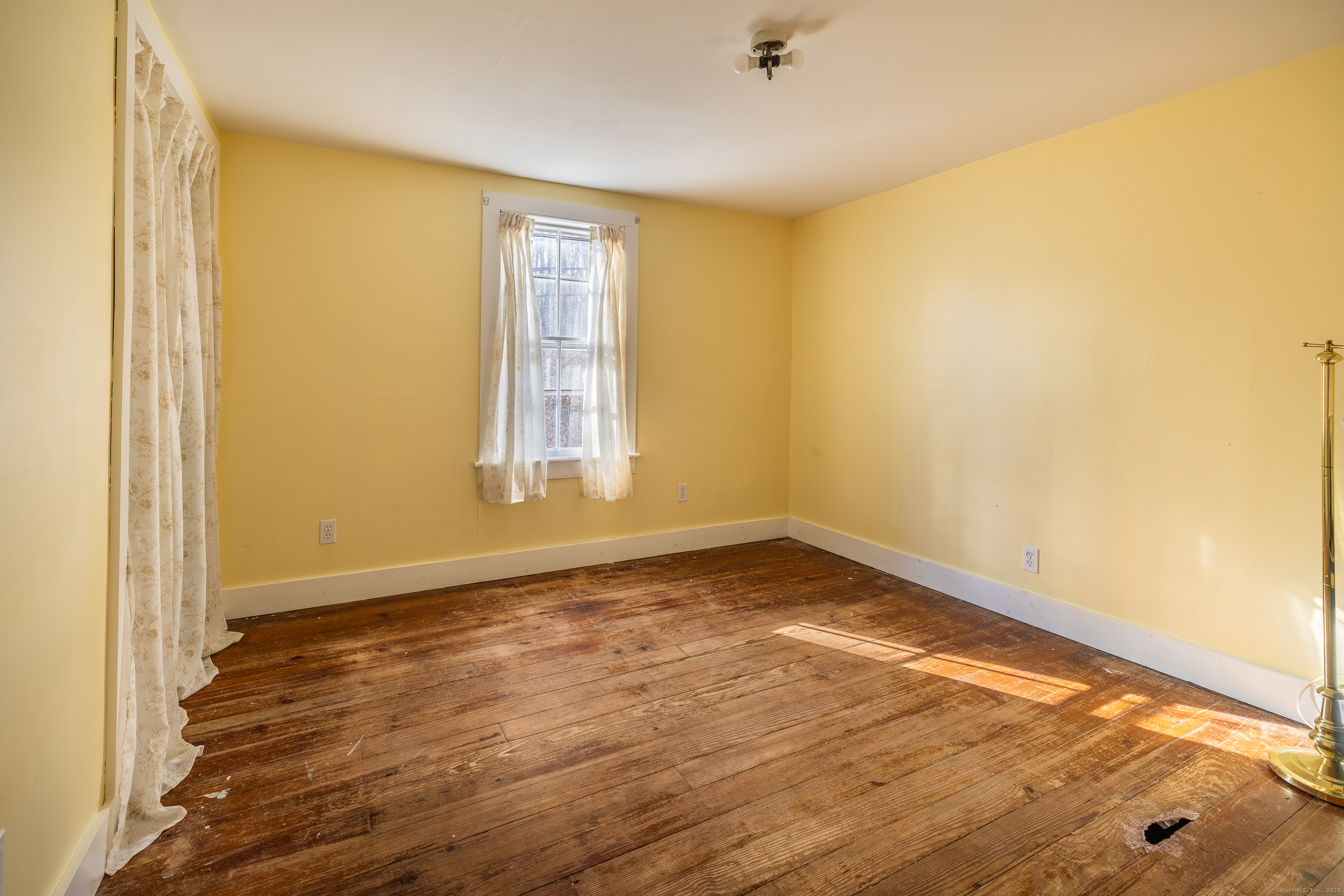 2 Stony Brook Road Newtown, CT 06470 - Photo 14 of 29 a view of an empty room with wooden floor and a window