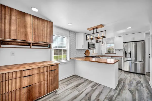 a kitchen with stainless steel appliances a sink stove and microwave