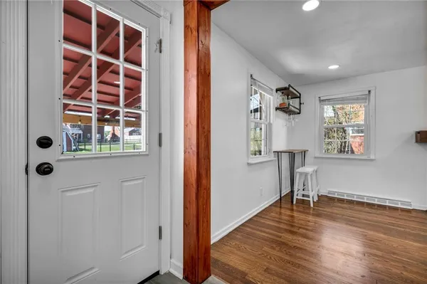 wooden floor in an empty room with a window