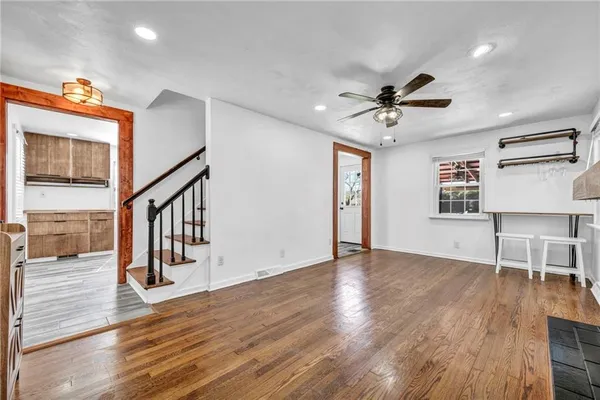 a view of an empty room window and wooden floor