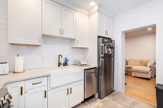 a kitchen with stainless steel appliances granite countertop a refrigerator sink and cabinets