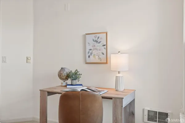 a bedroom with a bed and a night stand