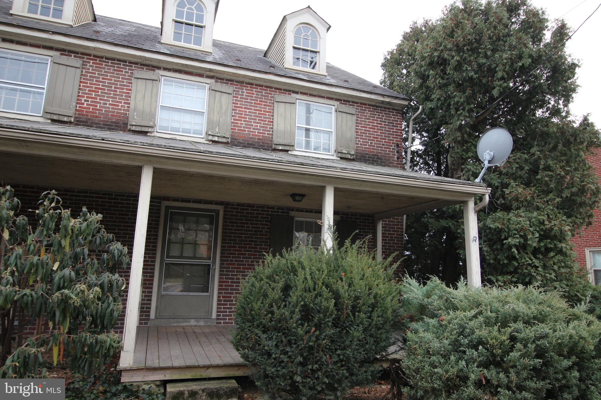 1076 Main Street East Earl, PA 17506 - Photo 2 of 11 front view of house with a potted plant