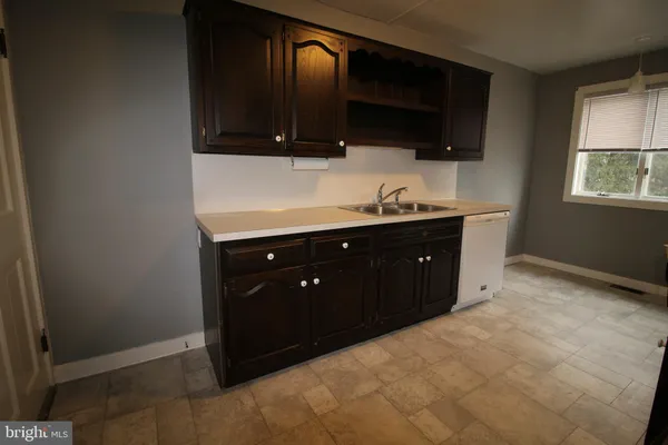a kitchen with a sink and a stove top oven