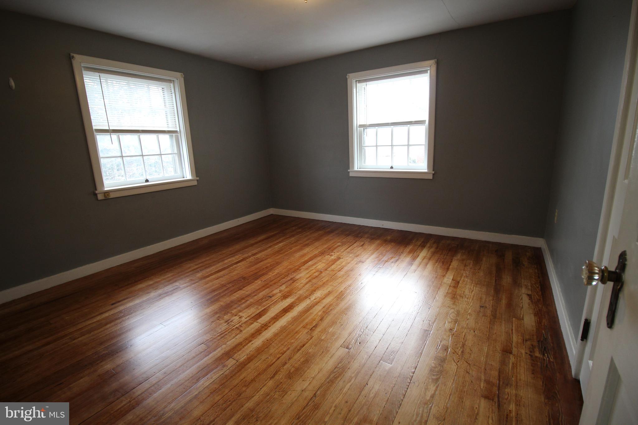 1076 Main Street East Earl, PA 17506 - Photo 7 of 11 an empty room with wooden floor and windows