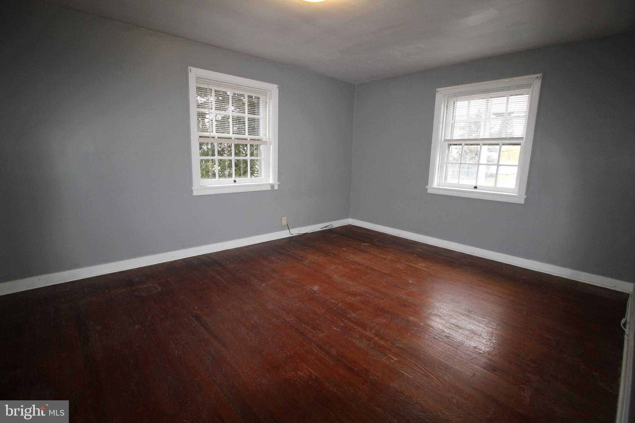 1076 Main Street East Earl, PA 17506 - Photo 8 of 11 a view of an empty room with wooden floor and a window