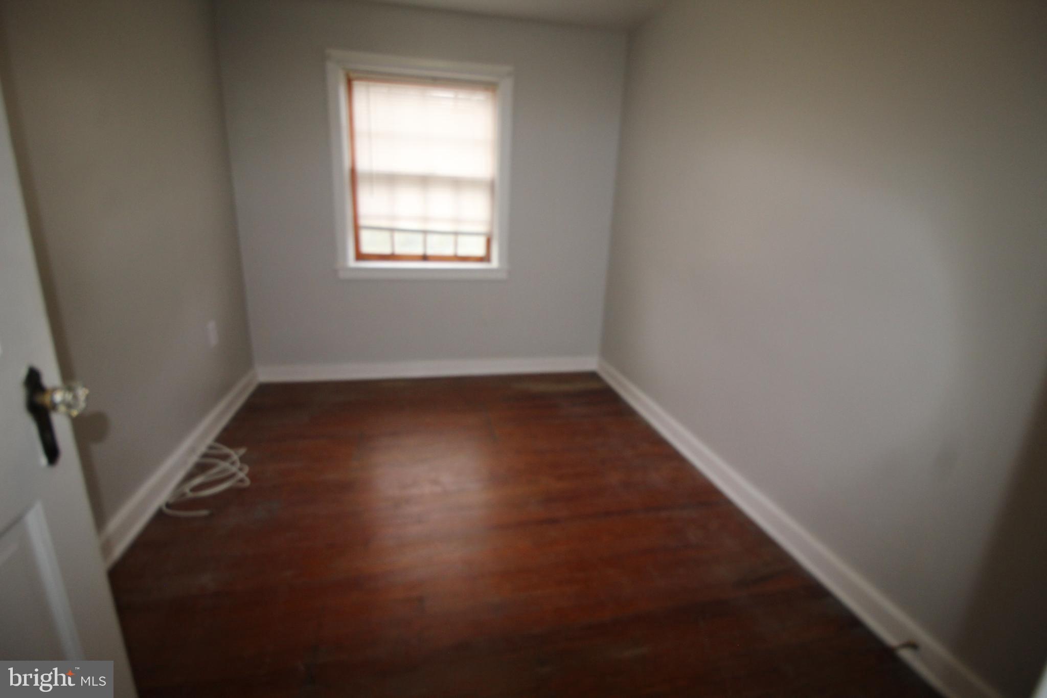 1076 Main Street East Earl, PA 17506 - Photo 9 of 11 an empty room with wooden floor and windows