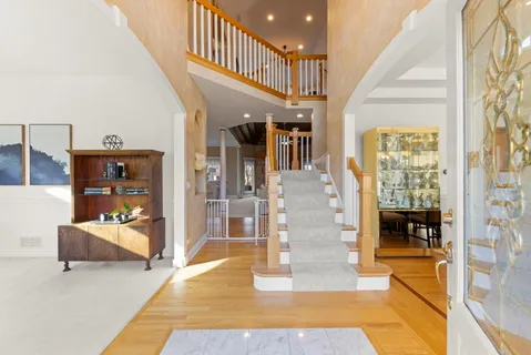 a living room with fireplace furniture and a rug