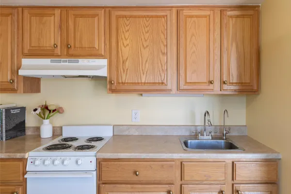 a kitchen with a stove and cabinets