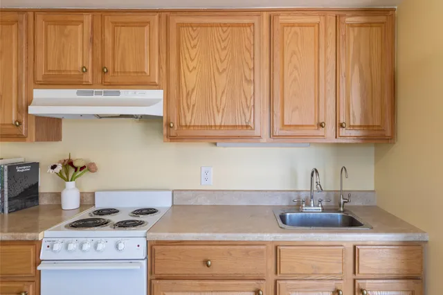 a kitchen with a stove and cabinets