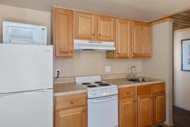 a view of a kitchen with sink and cabinets