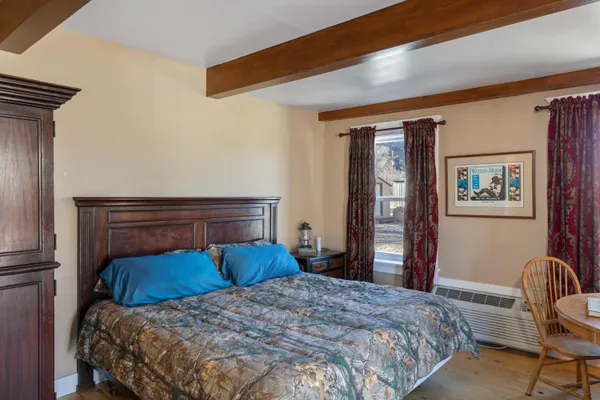 a bedroom with a large bed and a chair