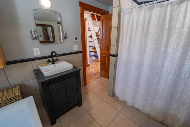 a bathroom with a sink a mirror and a shower