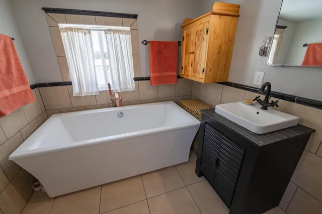 a bathroom with a bathtub and a sink