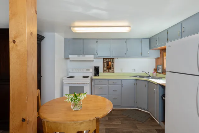 a kitchen with a sink cabinets and appliances