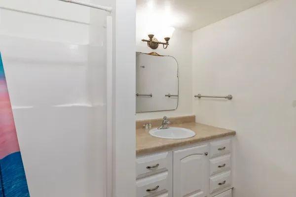a bathroom with a sink a mirror and a vanity