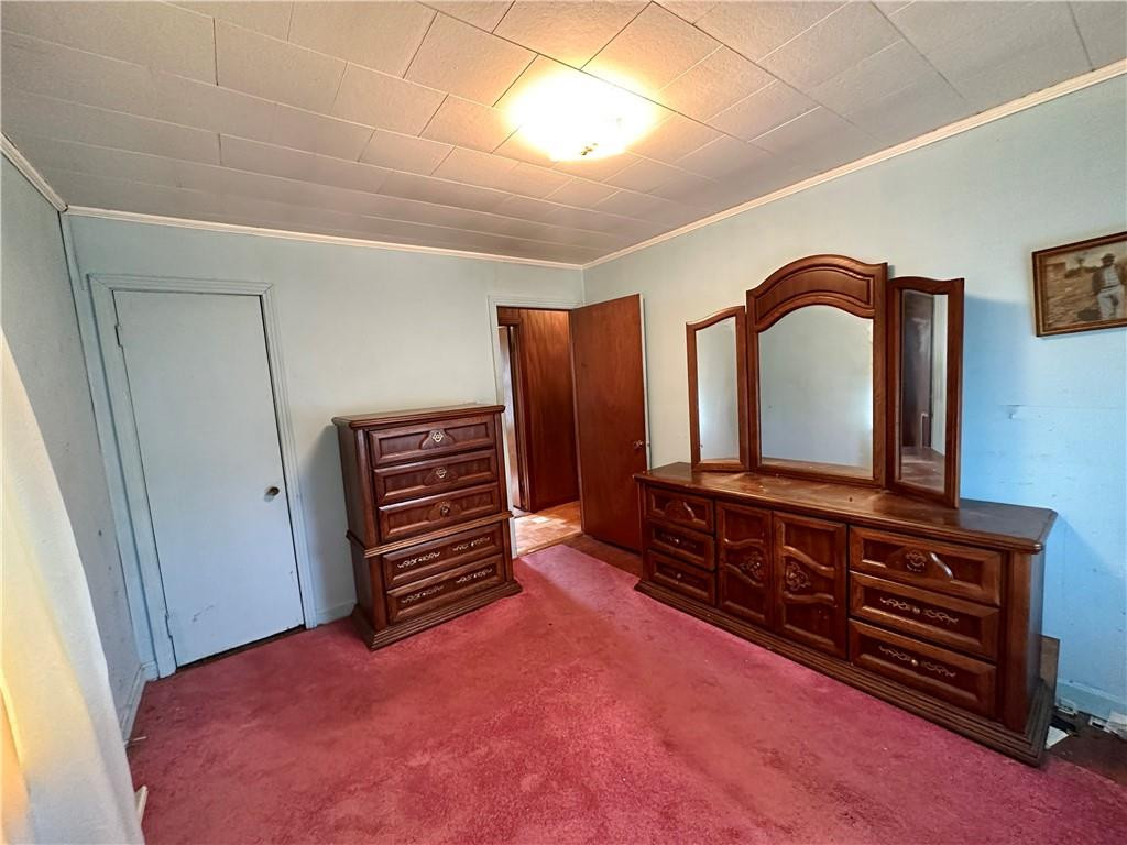 5545 Woodsdale Road Roxboro, NC 27574 - Photo 18 of 24 a bedroom with a bed and a dresser