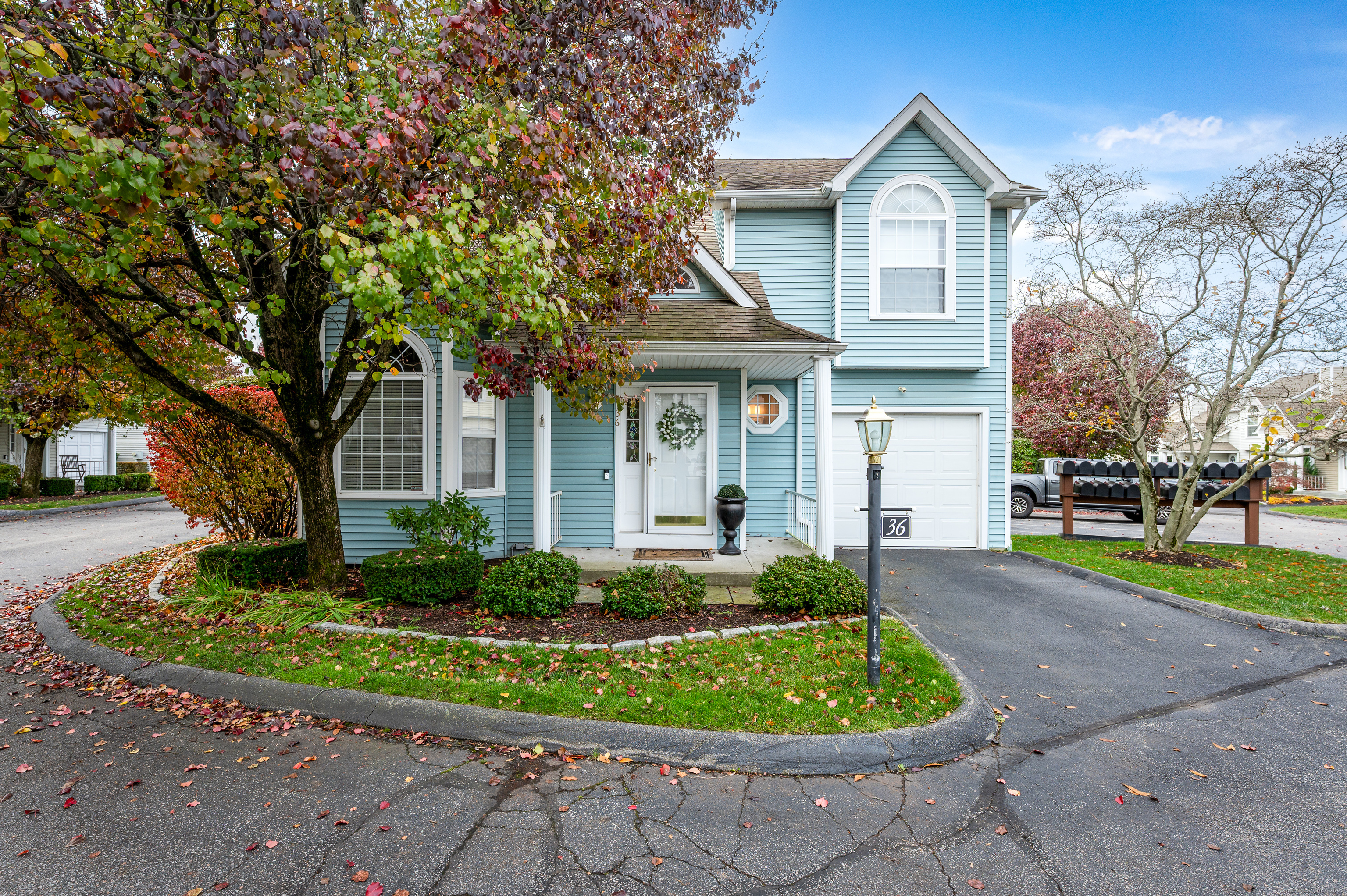 a front view of a house with a yard and potted plants
