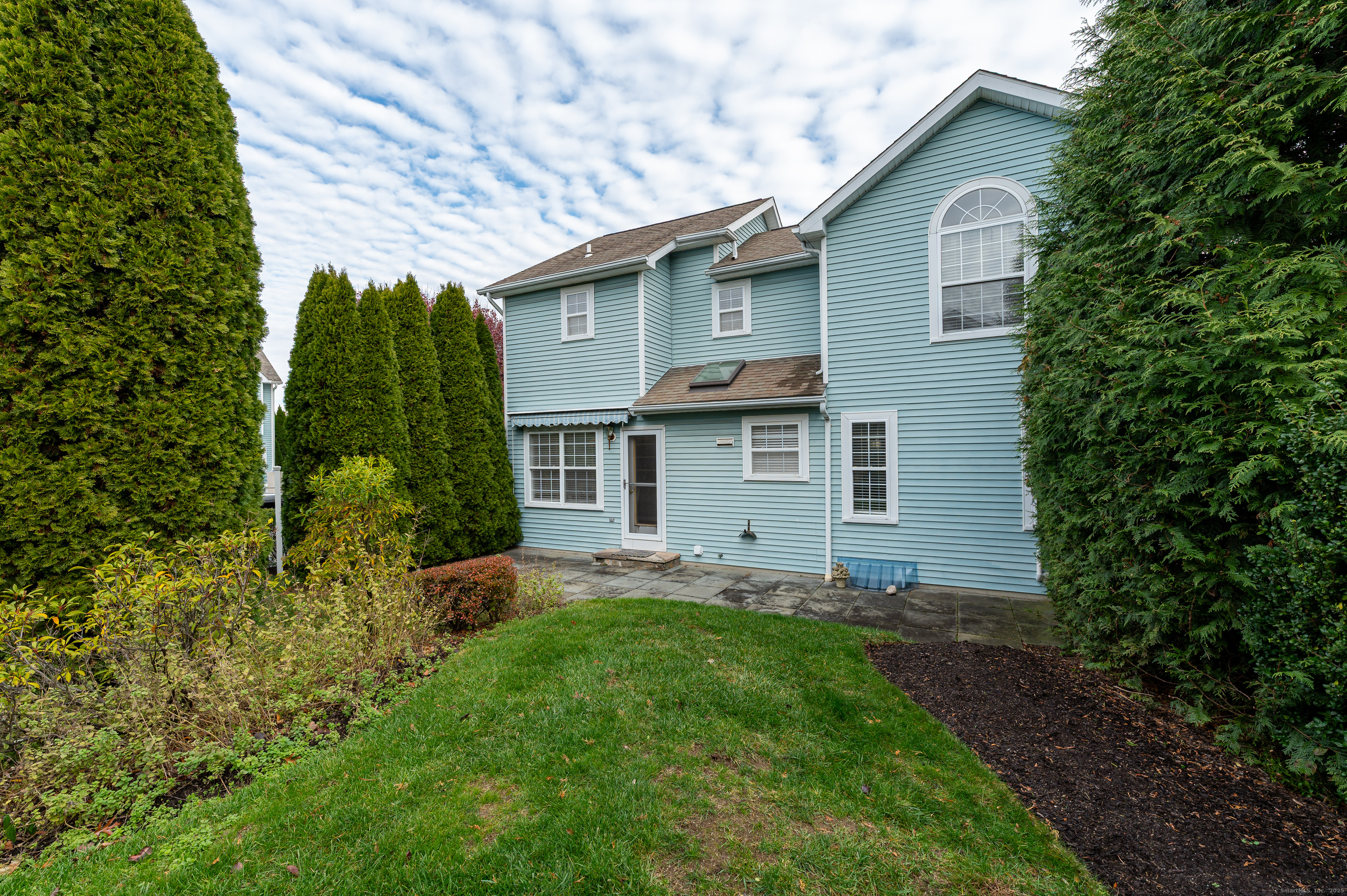 596 Glenbrook Road, Unit 36 Stamford, CT 06906 - Photo 20 of 25 a view of a house with a yard plants and large tree