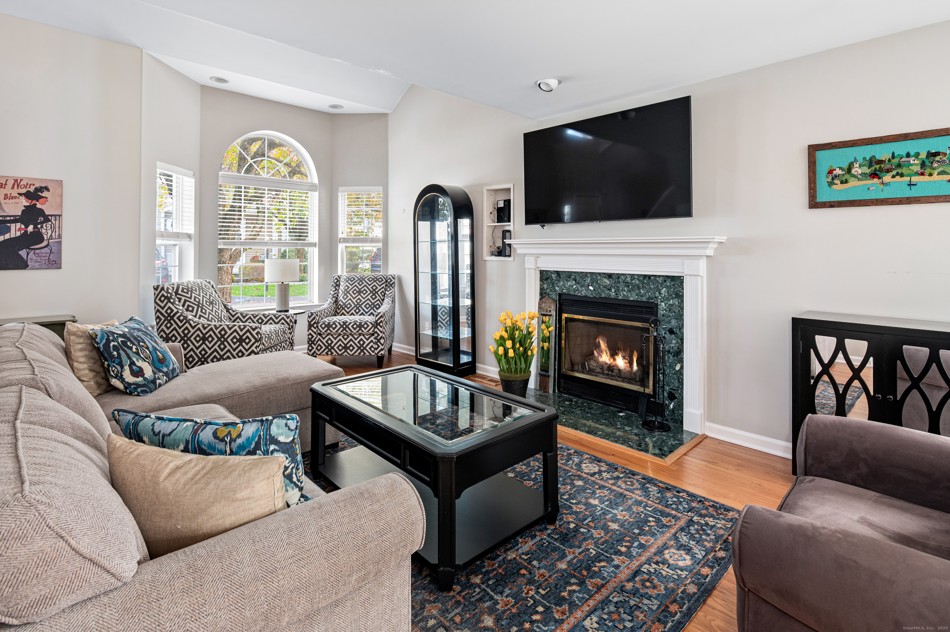 596 Glenbrook Road, Unit 36 Stamford, CT 06906 - Photo 3 of 25 a living room with furniture a flat screen tv and a fireplace