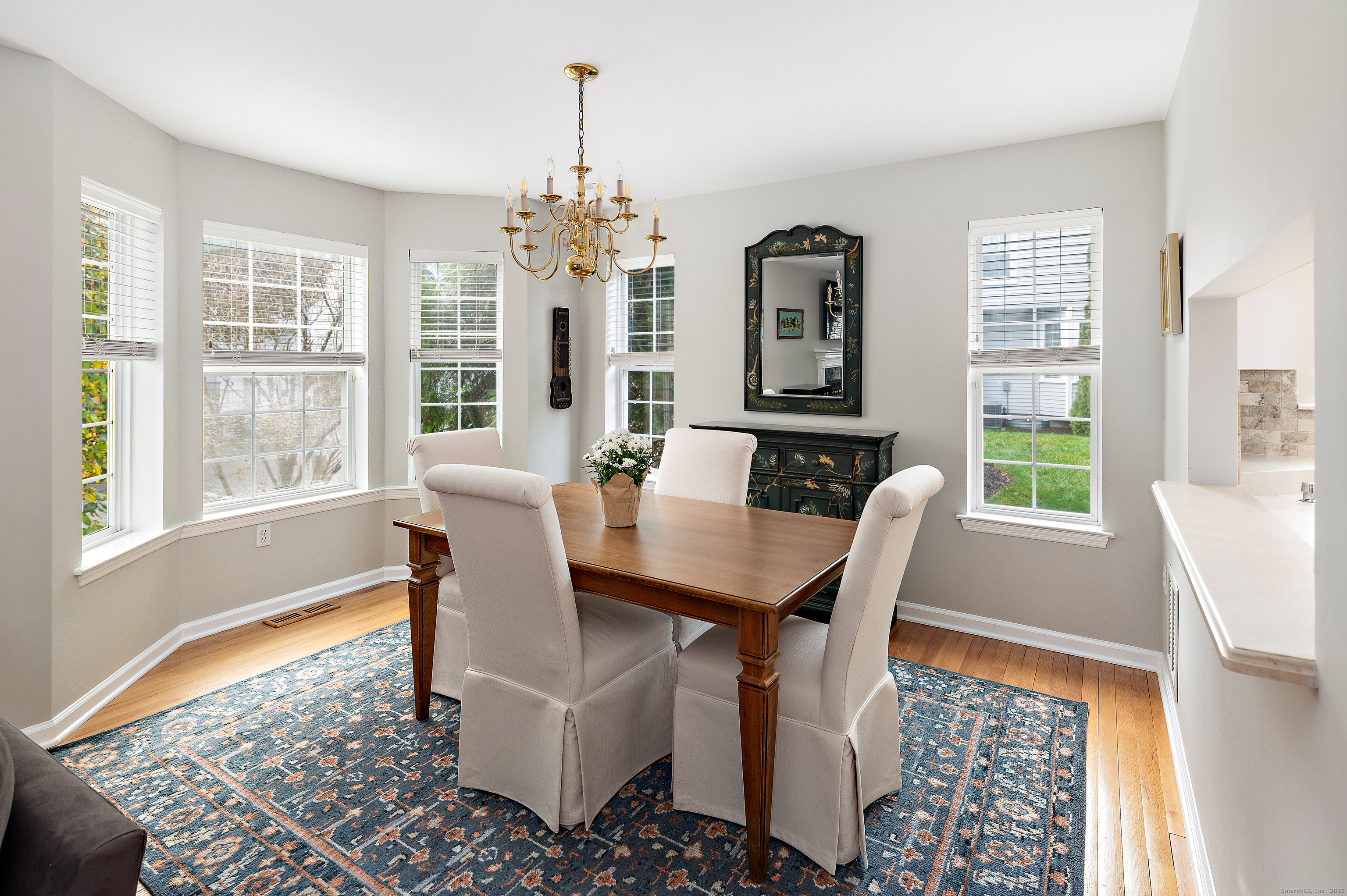 596 Glenbrook Road, Unit 36 Stamford, CT 06906 - Photo 5 of 25 a view of a dining room with furniture wooden floor and a chandelier