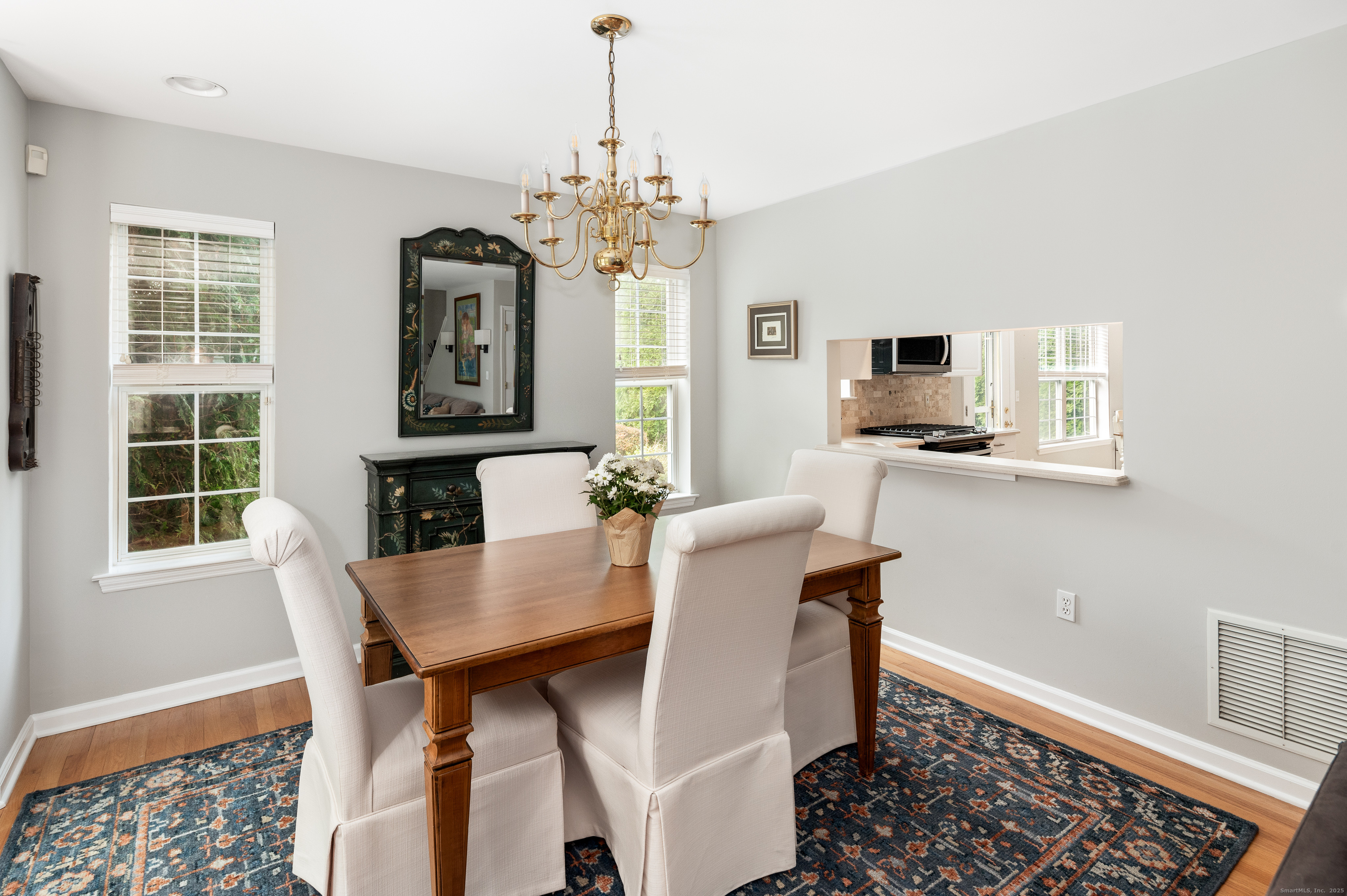 596 Glenbrook Road, Unit 36 Stamford, CT 06906 - Photo 6 of 25 a view of a dining room with furniture window and wooden floor