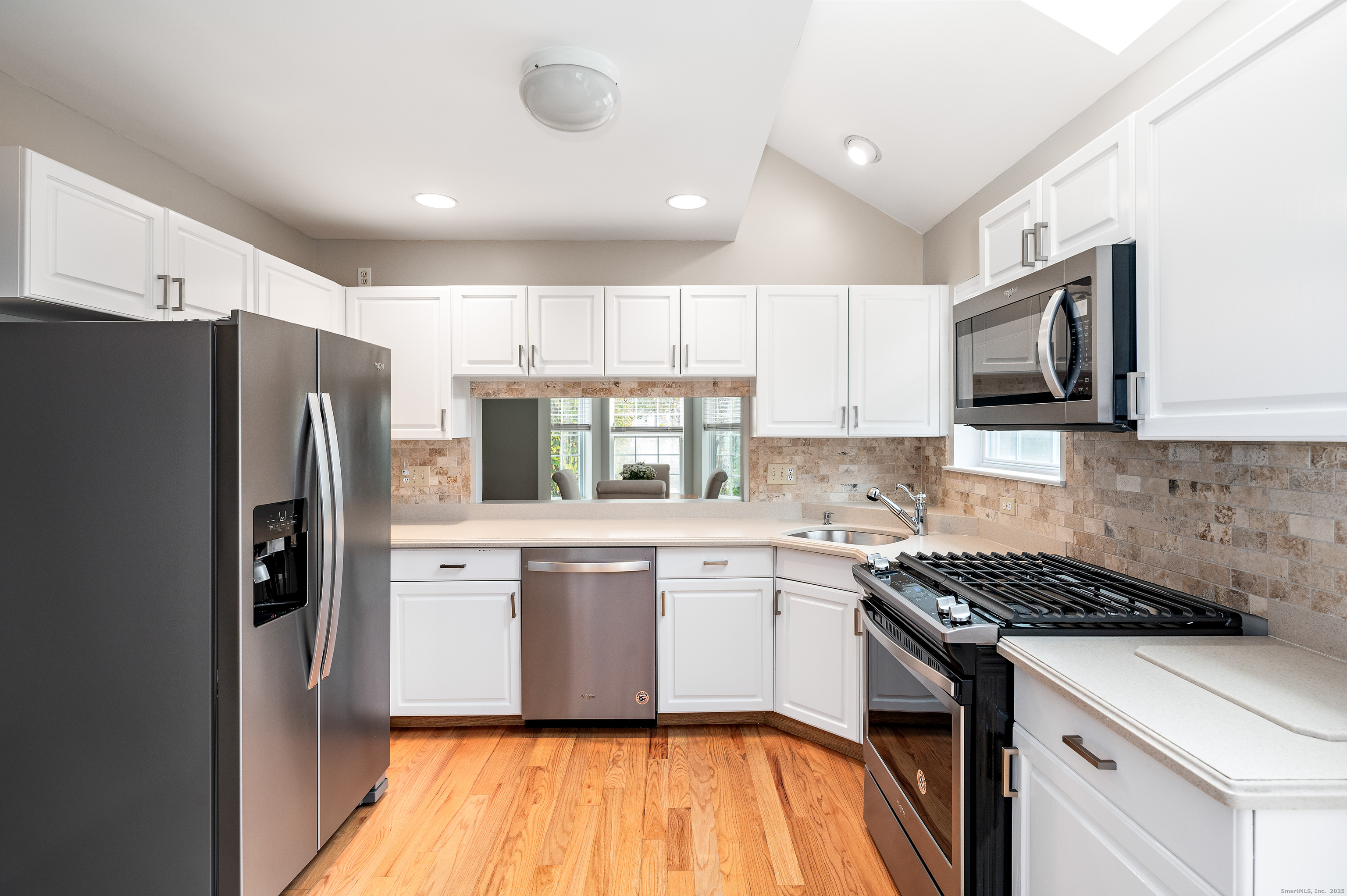 596 Glenbrook Road, Unit 36 Stamford, CT 06906 - Photo 7 of 25 a kitchen with stainless steel appliances a refrigerator stove microwave and sink