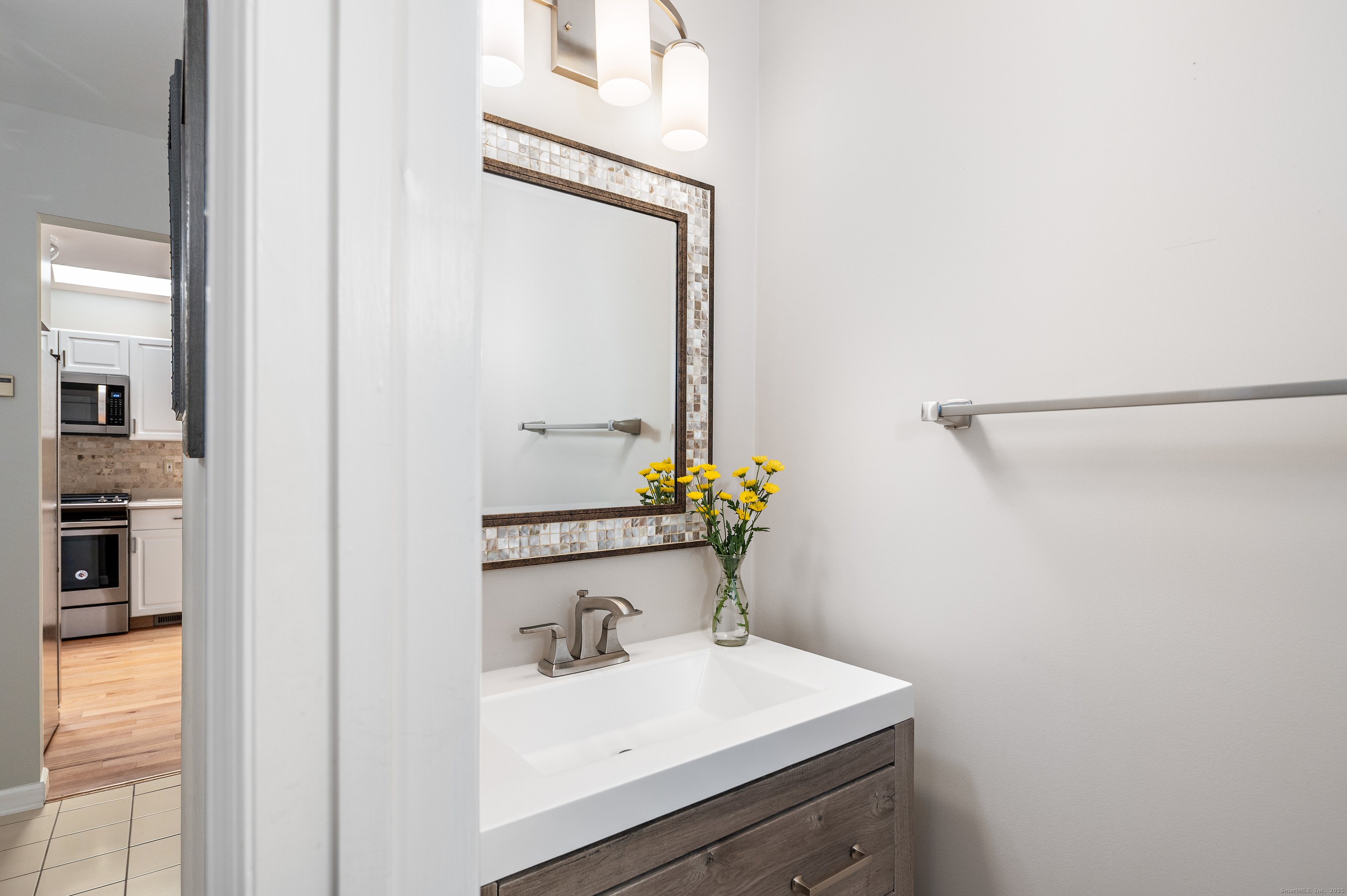 596 Glenbrook Road, Unit 36 Stamford, CT 06906 - Photo 10 of 25 a bathroom with a sink and a mirror