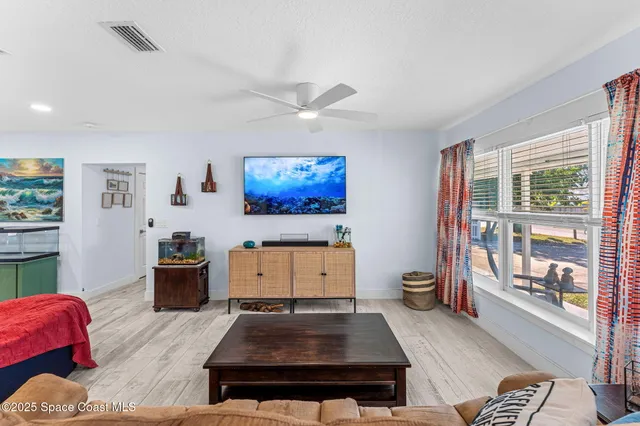 a living room with furniture and a floor to ceiling window