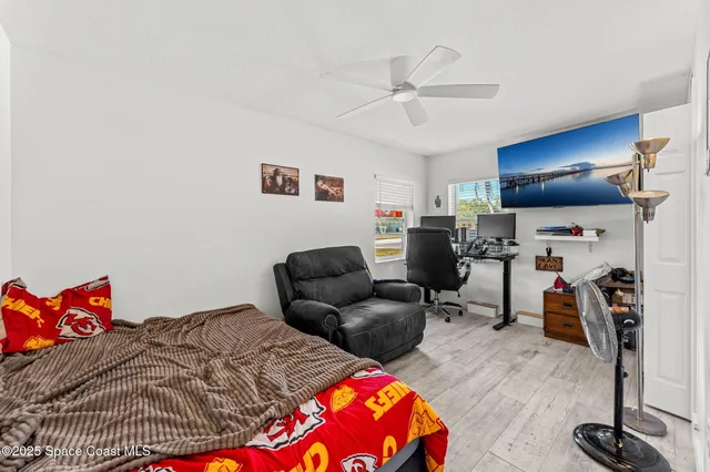 a bedroom with bed and a chandelier
