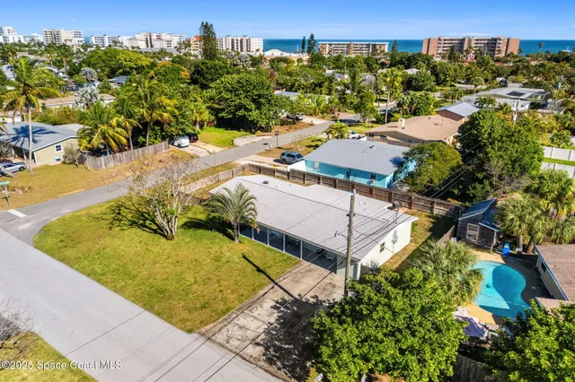 an aerial view of residential houses with outdoor space
