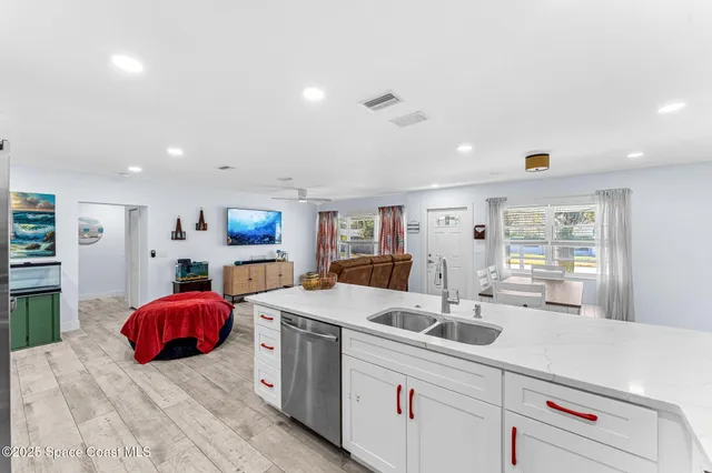 a view of kitchen with stainless steel appliances kitchen island a sink and a refrigerator