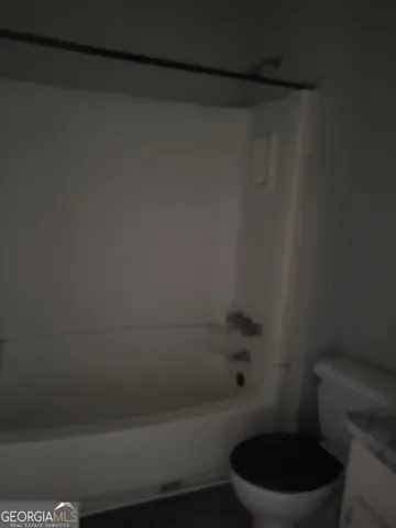 a bath room with a toilet and a shower