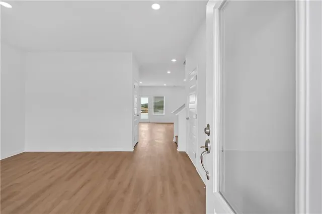 a view of a hallway with wooden floor