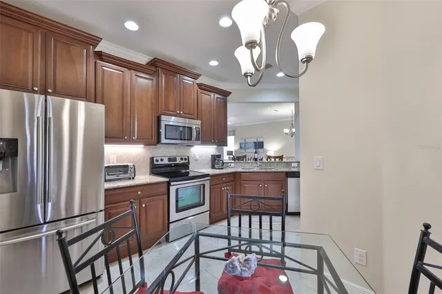 a living room with furniture a chandelier and a rug