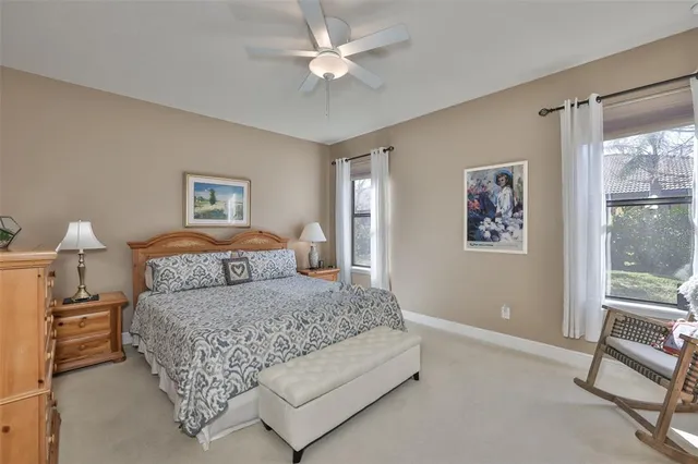 a bedroom with a bed and a large window