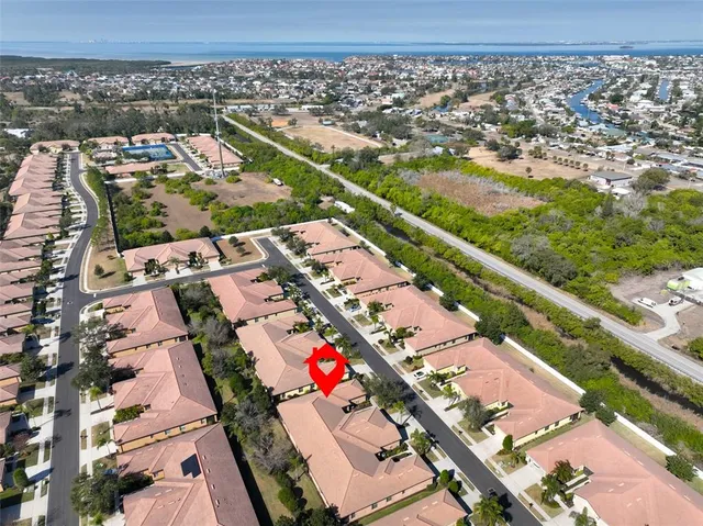 an aerial view of a pool patio lake and mountain view