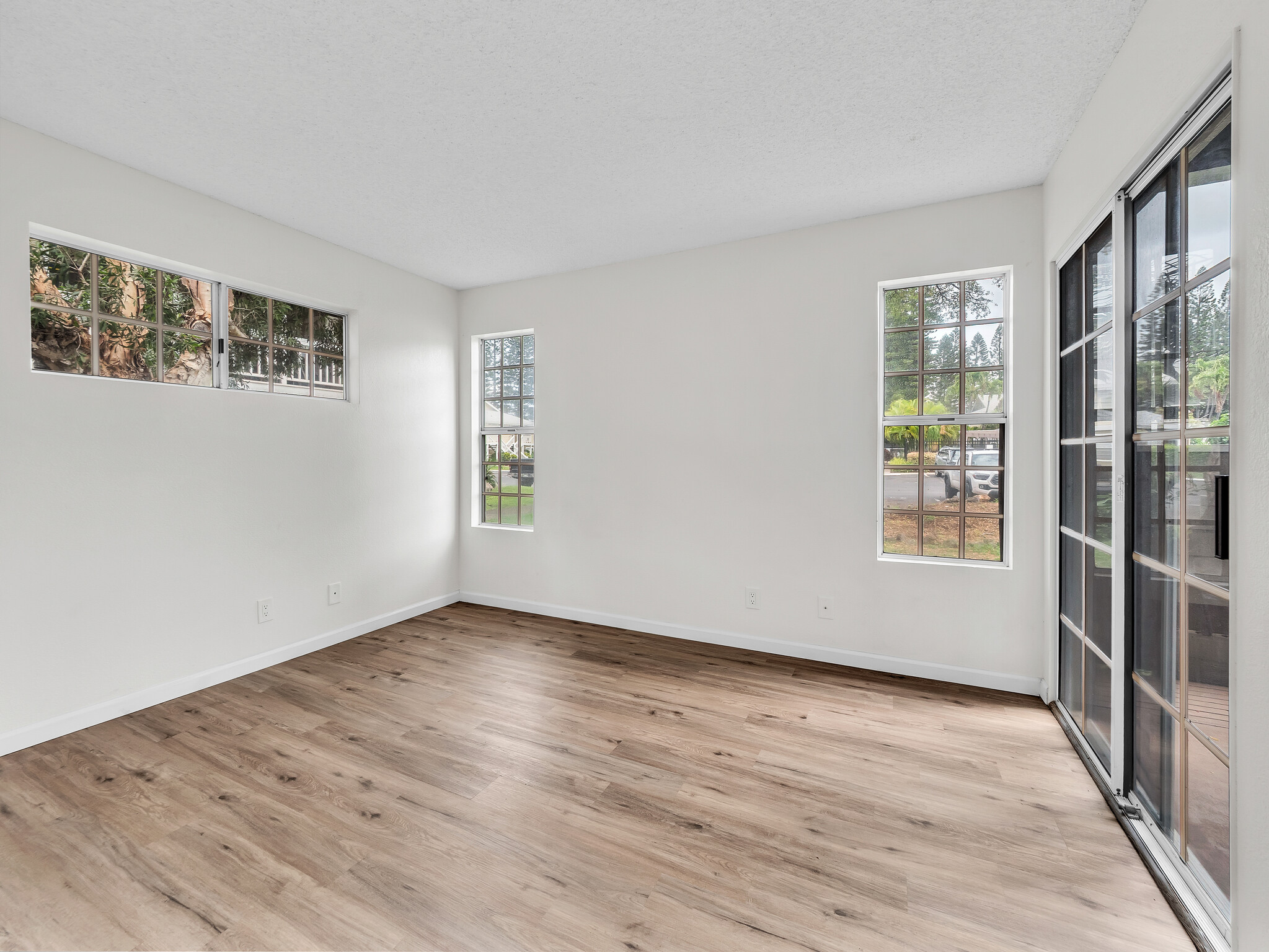 68-3883 Lua Kula Street, Unit 2102 Waikoloa, HI 96738 - Photo 11 of 29 a view of an empty room with wooden floor and a window