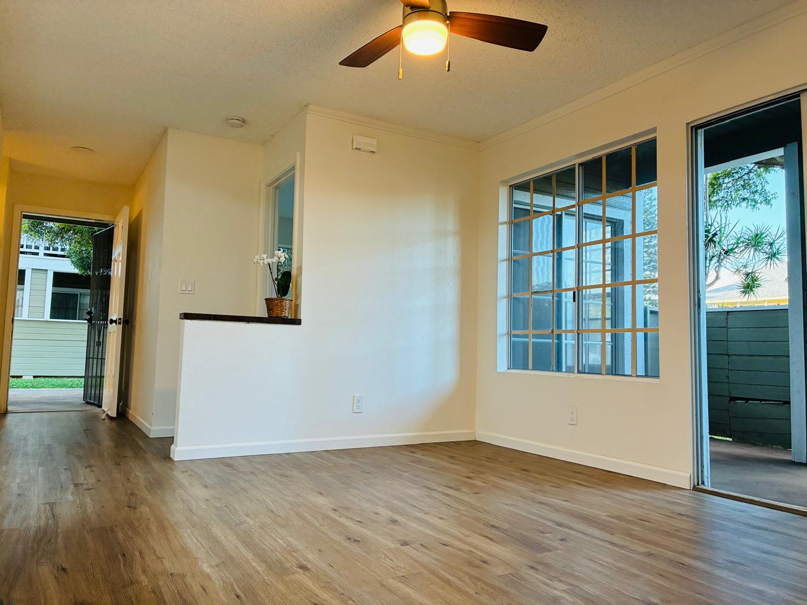 68-3883 Lua Kula Street, Unit 2102 Waikoloa, HI 96738 - Photo 12 of 21 an empty room with wooden floor and windows