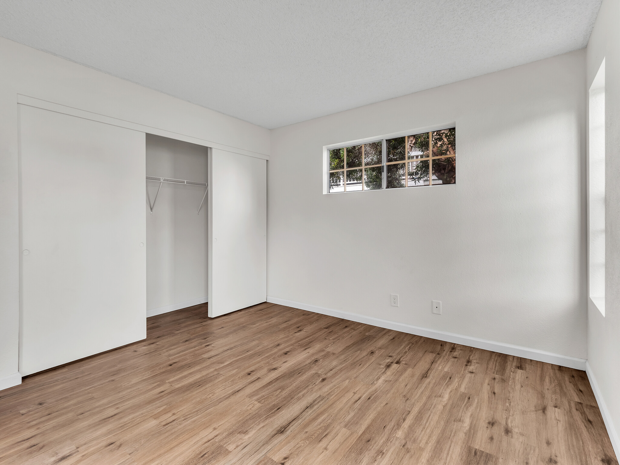 68-3883 Lua Kula Street, Unit 2102 Waikoloa, HI 96738 - Photo 12 of 29 a view of an empty room with wooden floor and a window