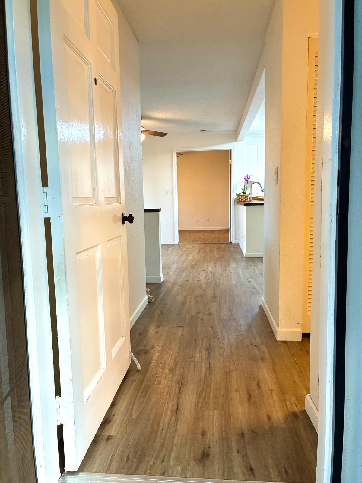 68-3883 Lua Kula Street, Unit 2102 Waikoloa, HI 96738 - Photo 13 of 21 a view of a hallway with wooden floor and furniture