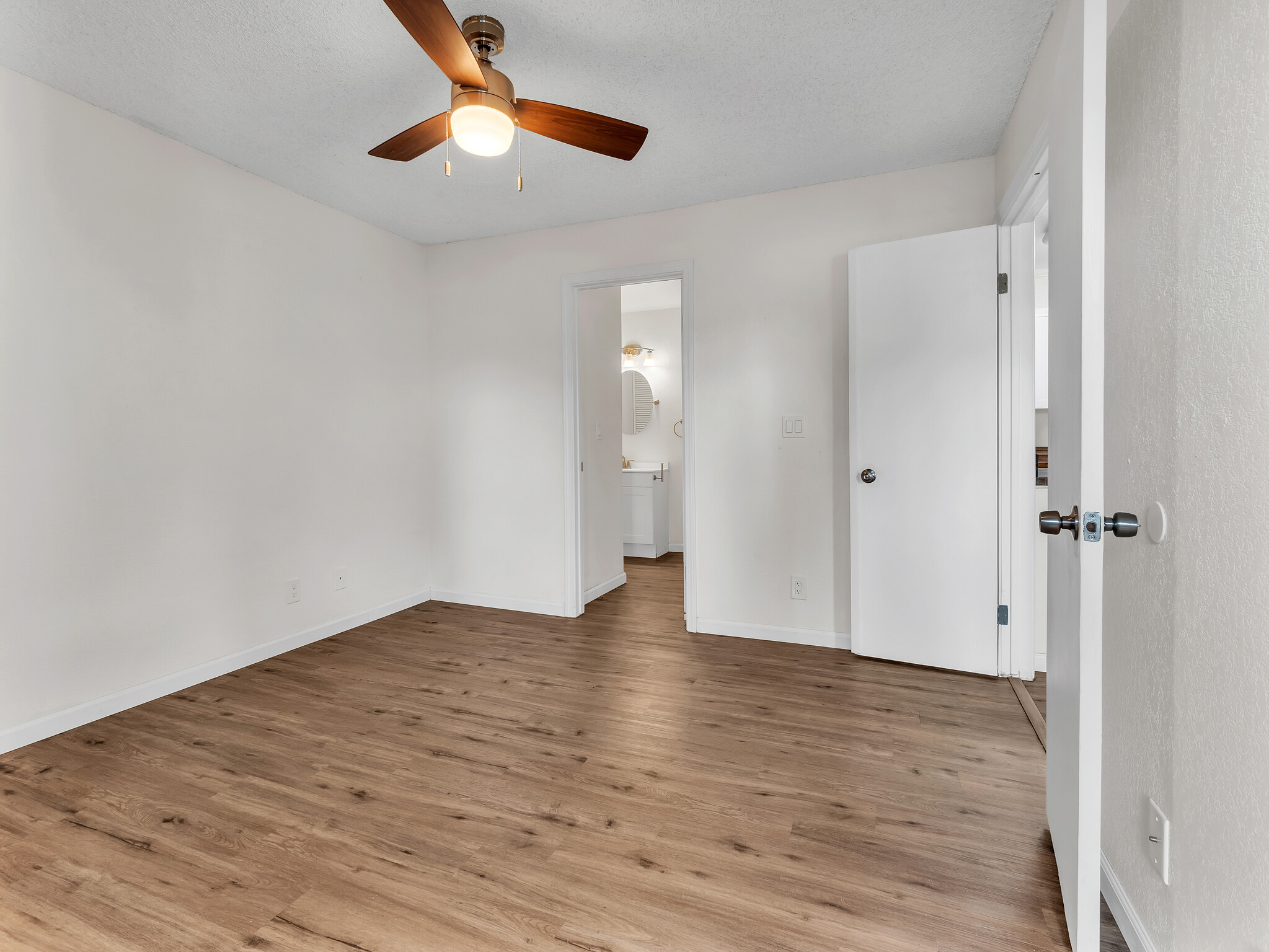 68-3883 Lua Kula Street, Unit 2102 Waikoloa, HI 96738 - Photo 16 of 29 a view of an empty room with window and wooden floor