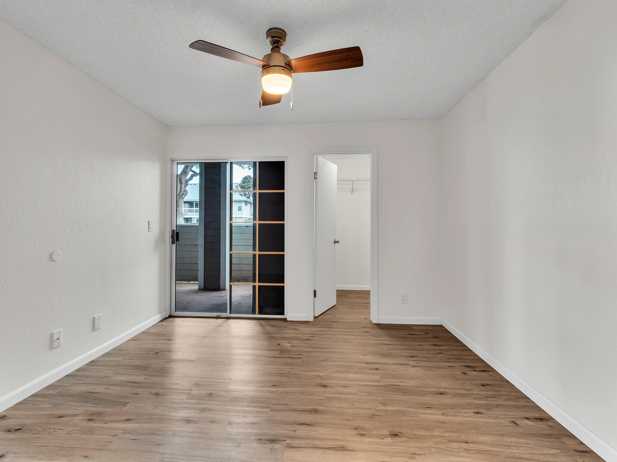 68-3883 Lua Kula Street, Unit 2102 Waikoloa, HI 96738 - Photo 18 of 29 wooden floor in an empty room with a window