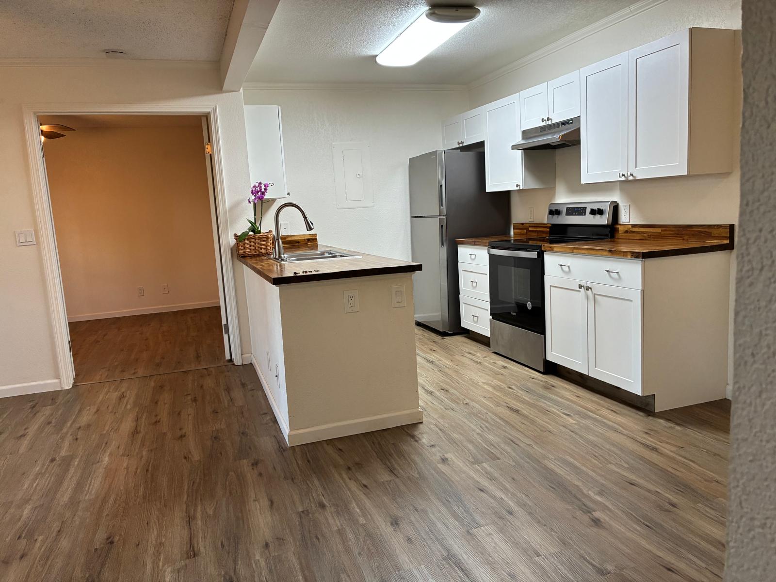68-3883 Lua Kula Street, Unit 2102 Waikoloa, HI 96738 - Photo 19 of 21 a kitchen with granite countertop a refrigerator stove top oven and sink
