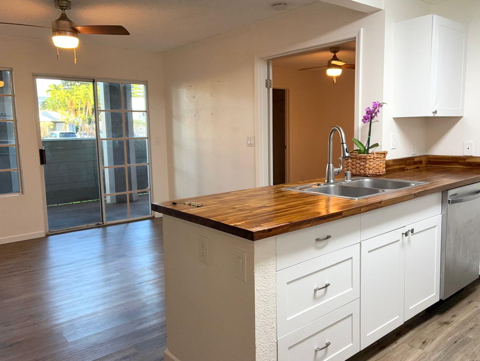 68-3883 Lua Kula Street, Unit 2102 Waikoloa, HI 96738 - Photo 2 of 21 a kitchen with sink cabinets and wooden floor