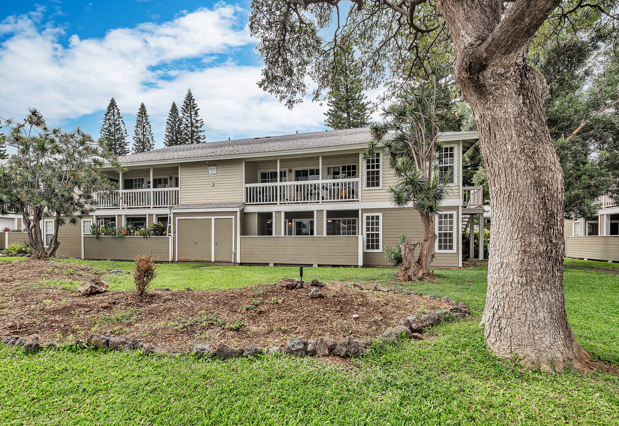 68-3883 Lua Kula Street, Unit 2102 Waikoloa, HI 96738 - Photo 28 of 29 a view of a house with a yard and large trees