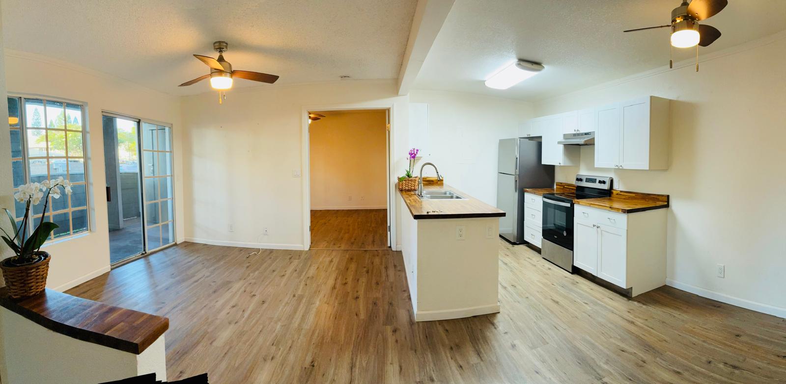 68-3883 Lua Kula Street, Unit 2102 Waikoloa, HI 96738 - Photo 3 of 21 a view of a kitchen with furniture and wooden floor