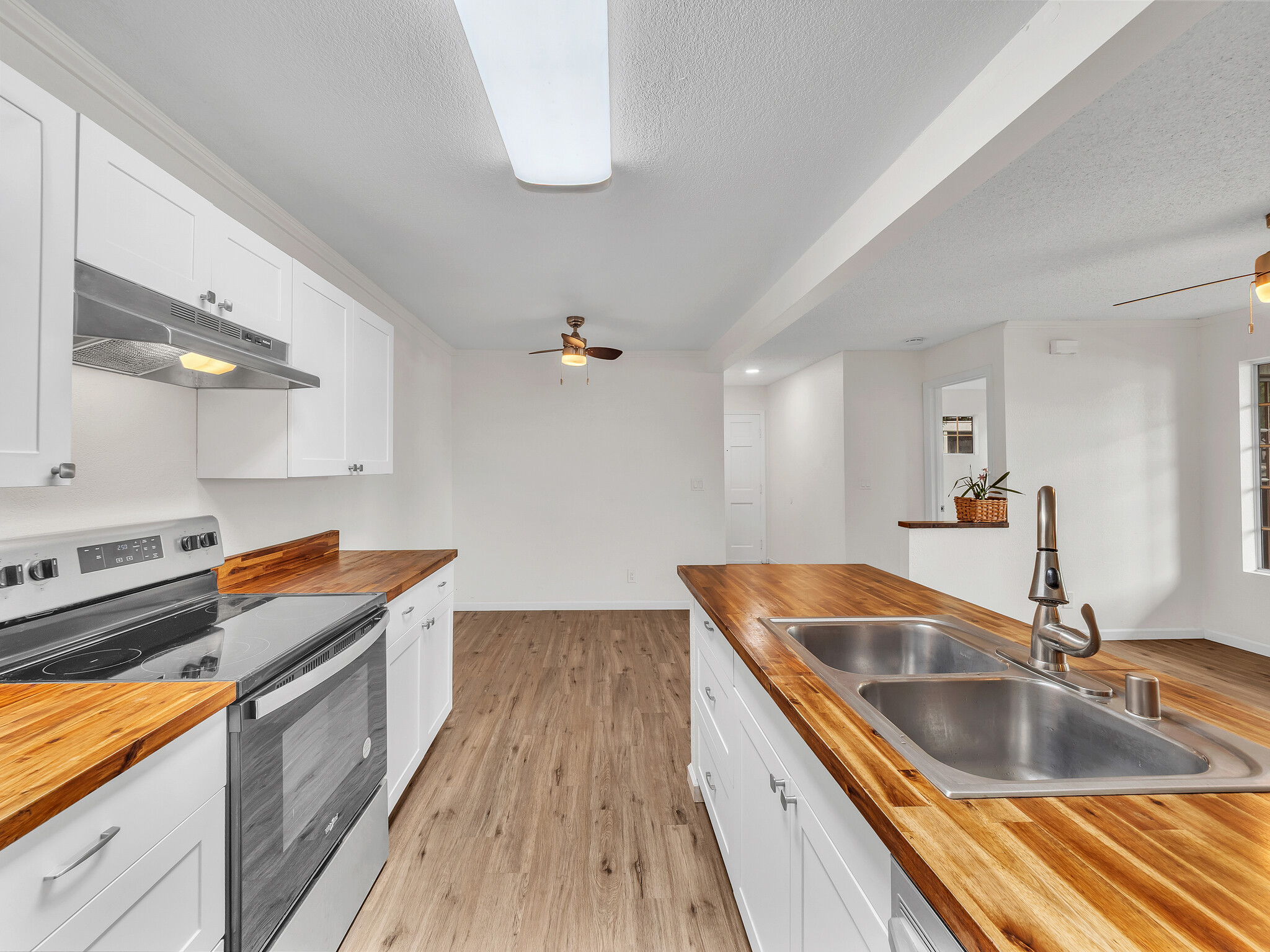 68-3883 Lua Kula Street, Unit 2102 Waikoloa, HI 96738 - Photo 4 of 29 a kitchen with stainless steel appliances granite countertop a sink and a stove